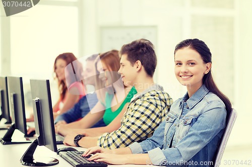 Image of female student with classmates in computer class