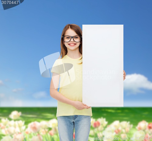 Image of little girl wearing eyeglasses with blank board