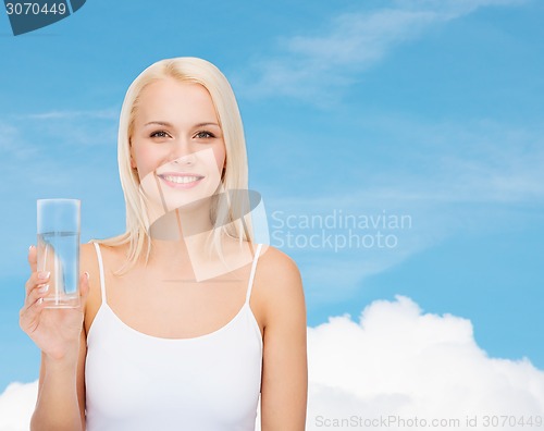 Image of young smiling woman with glass of water