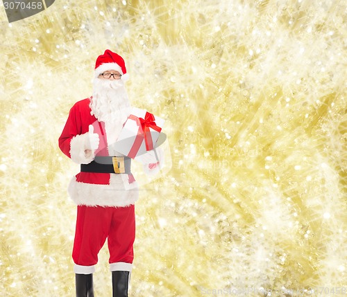 Image of man in costume of santa claus with gift box