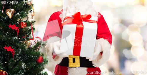 Image of man in costume of santa claus with gift box