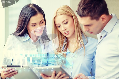 Image of business team working with tablet pcs in office