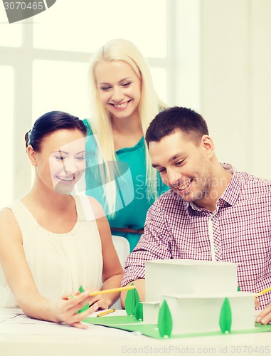 Image of smiling architects working in office