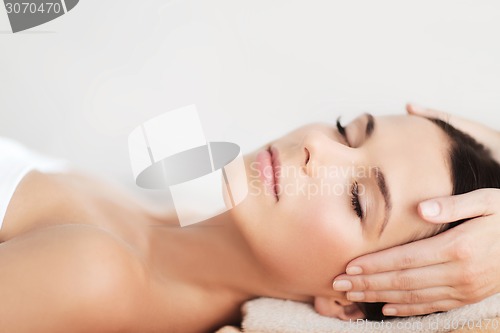 Image of beautiful woman in spa salon having facial