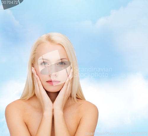 Image of beautiful woman touching her face skin