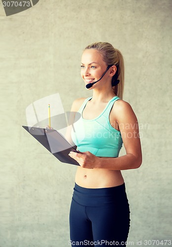 Image of beautiful athletic woman in gym