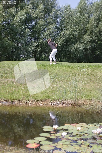 Image of Female golfer playing golf