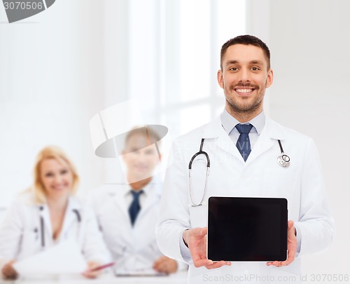 Image of smiling male doctor with tablet pc