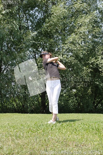 Image of Female golfer playing golf