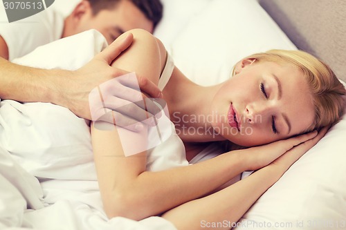 Image of happy couple sleeping in bed