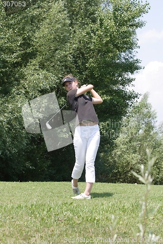 Image of Female golfer playing golf