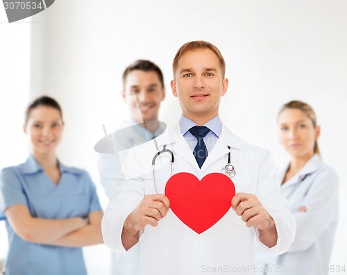 Image of smiling male doctor with red heart and stethoscope