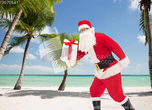 Image of man in costume of santa claus with gift box