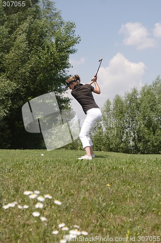 Image of Female golfer playing golf