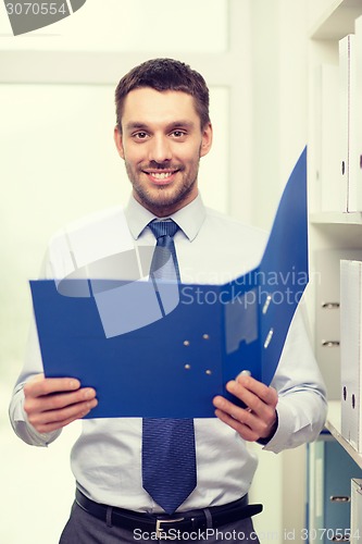 Image of businessman with folder at office