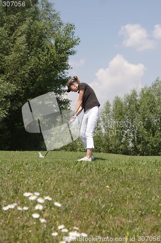 Image of Female golfer playing golf