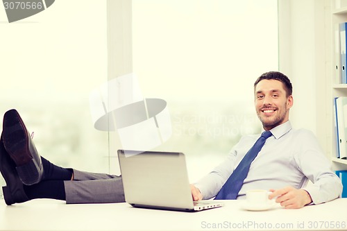 Image of smiling businessman or student with laptop