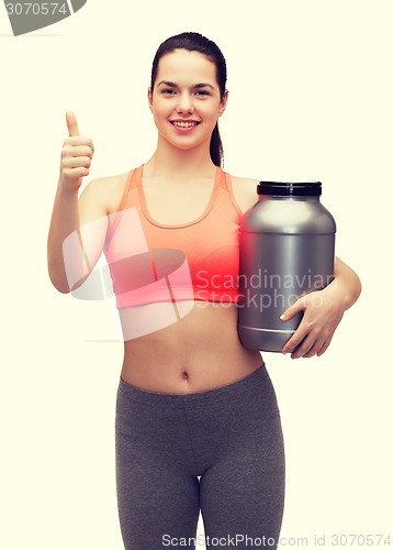 Image of teenage girl with jar of protein showing thumbs up