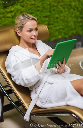 Image of beautiful young woman with smartphone at spa