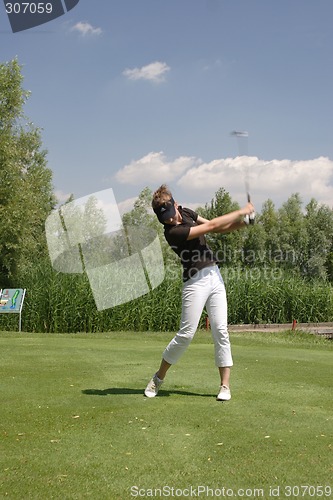 Image of Female golfer playing golf