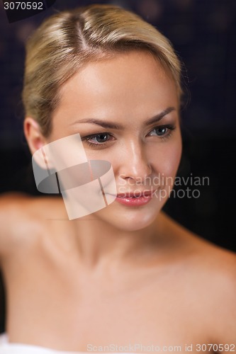 Image of close up of young woman sitting in bath towel