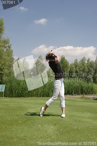 Image of Female golfer playing golf