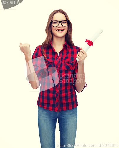 Image of smiling female student in eyeglasses with diploma