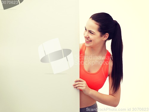 Image of teenage girl in sportswear with white board