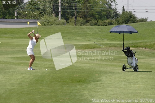 Image of Female golfer playing golf