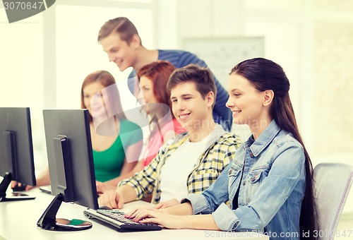 Image of female student with classmates in computer class