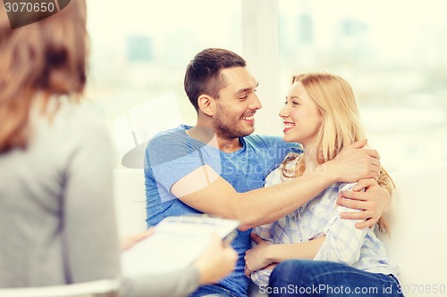 Image of young couple hugging at psychologist office