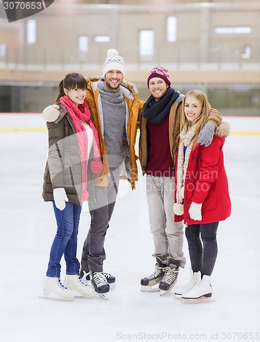 Image of happy friends on skating rink