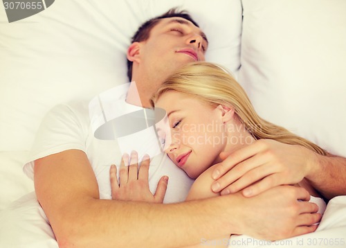 Image of happy couple sleeping in bed