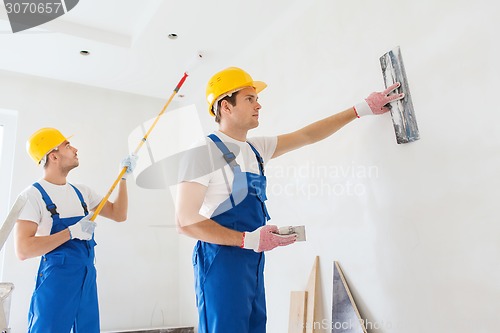 Image of group of builders with tools indoors