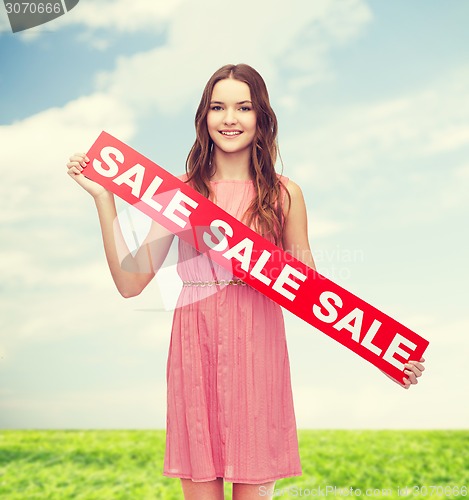 Image of young woman in dress with sale sign
