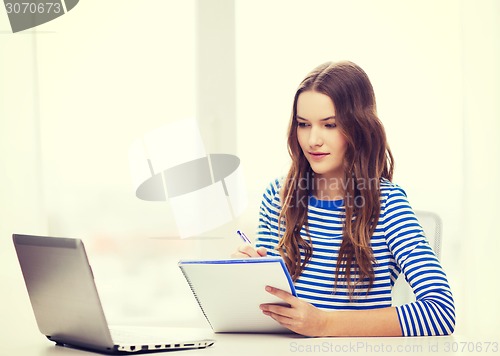 Image of teenage girl laptop computer and notebook