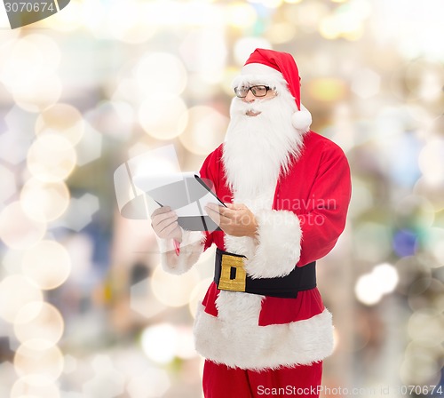 Image of man in costume of santa claus with notepad