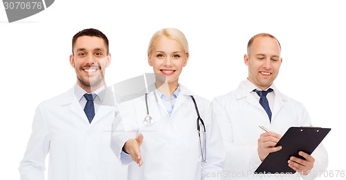Image of group of doctors making handshake gesture