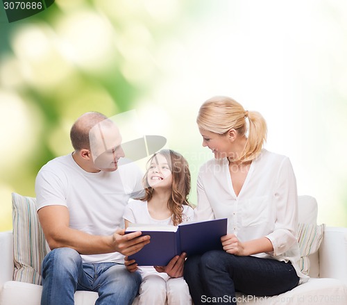 Image of happy family with book at home