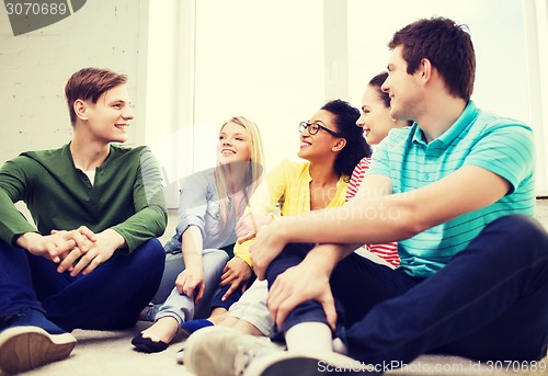 Image of five smiling teenagers having fun at home