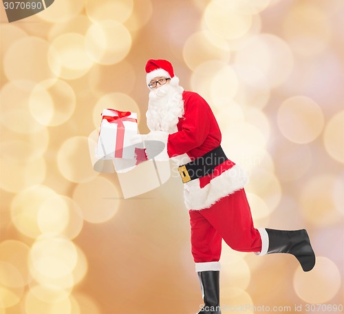 Image of man in costume of santa claus with gift box