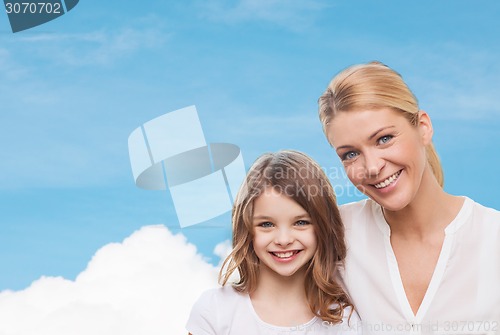 Image of smiling mother and little girl