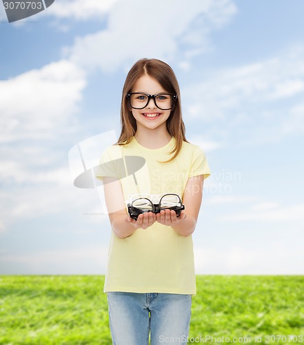 Image of smiling cute little girl in black eyeglasses