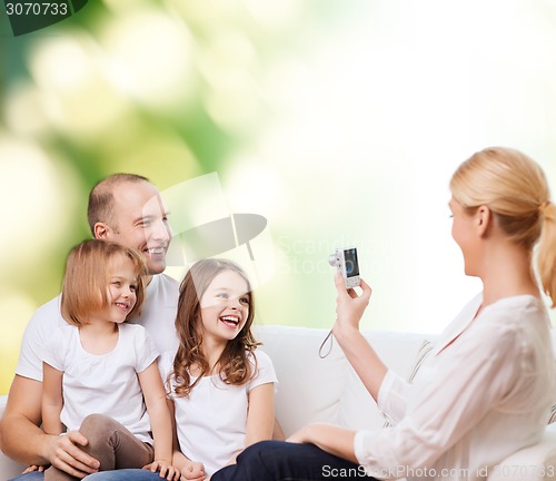 Image of happy family with camera at home
