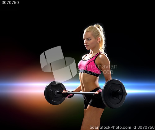 Image of sporty woman exercising with barbell