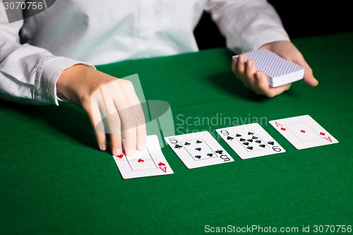 Image of holdem dealer with playing cards