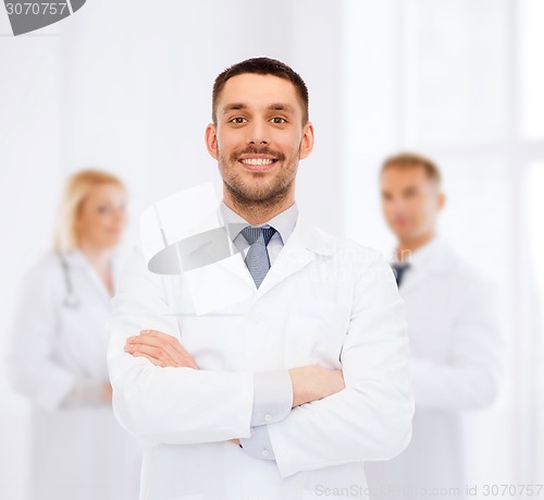 Image of smiling male doctor in white coat