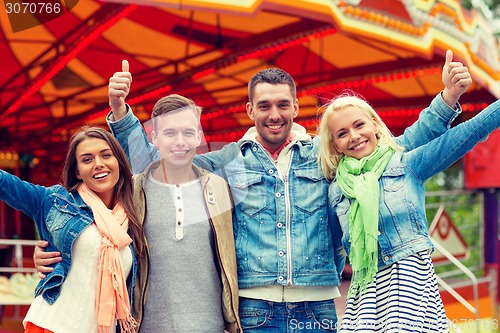 Image of group of smiling friends showing thumbs up