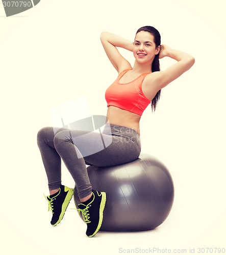 Image of teenage girl doing exercise on fitness ball