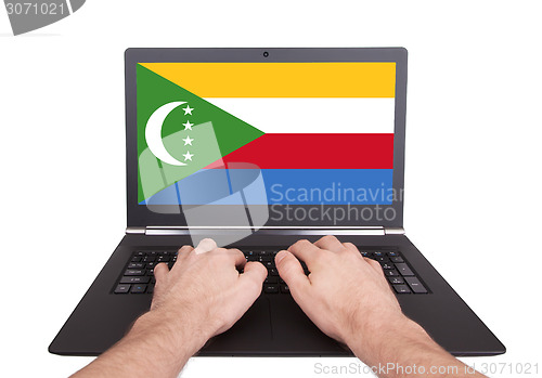 Image of Hands working on laptop, Comoros